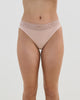 Model wears Cotton And Lace Thong in LATTE. On body front view