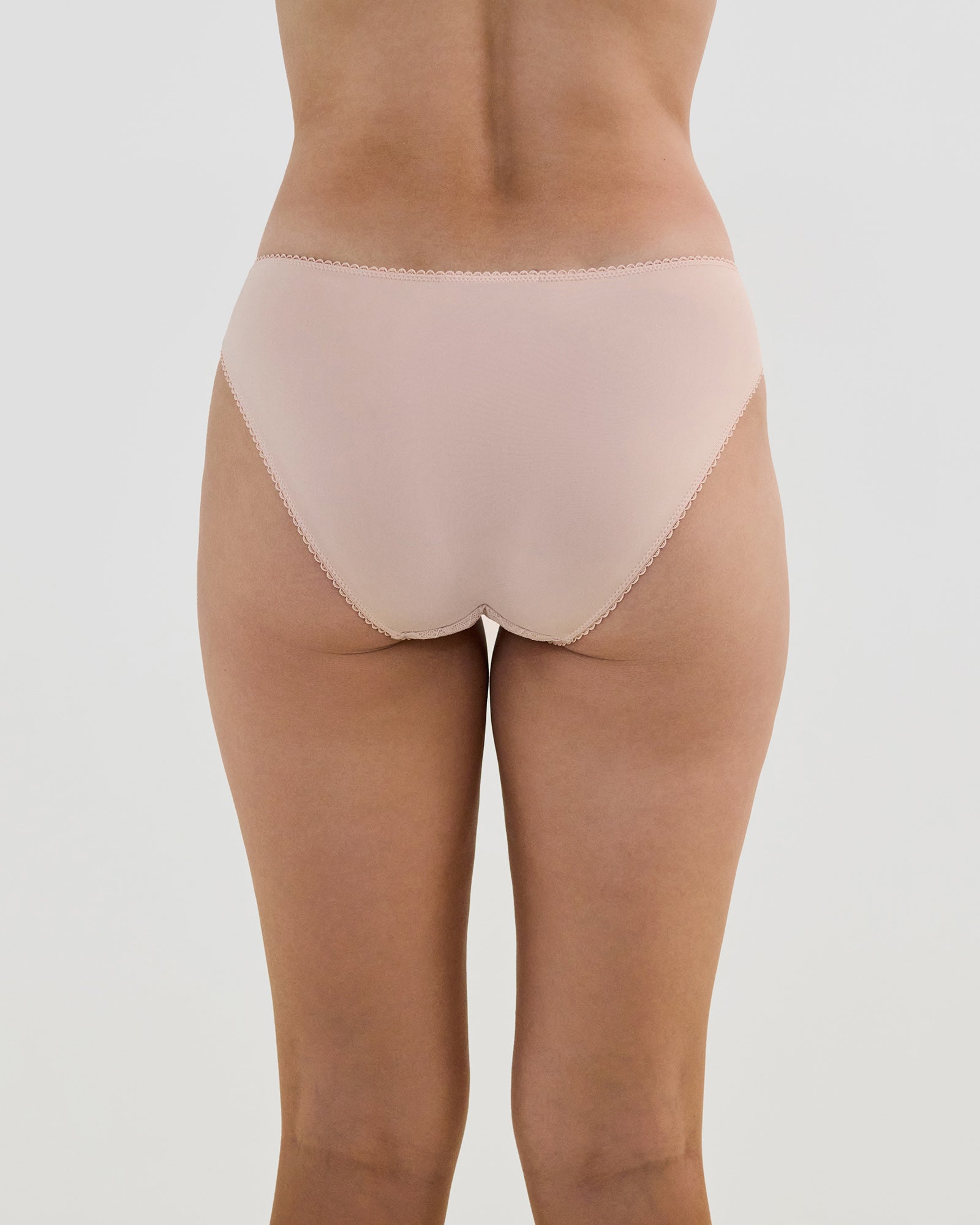 Model wears Lacey Bikini in LATTE. On body back view