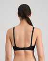 Model wears Simply Seamless Wire Free Bra in BLACK. On body back view