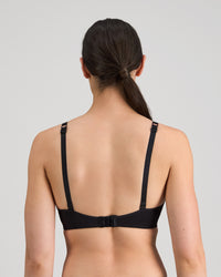 Model wears Simply Seamless Wire Free Bra in BLACK. On body back view
