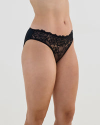 Model wears Lacey Bikini in BLACK. On body side view