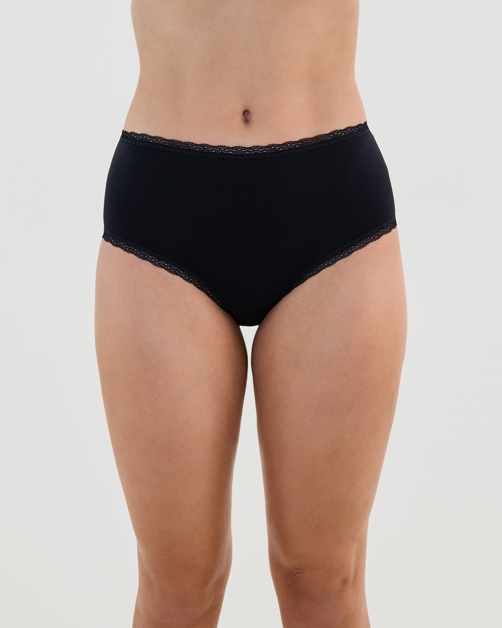 Model wears Stretch Cotton Full Brief in BLACK. On body front view