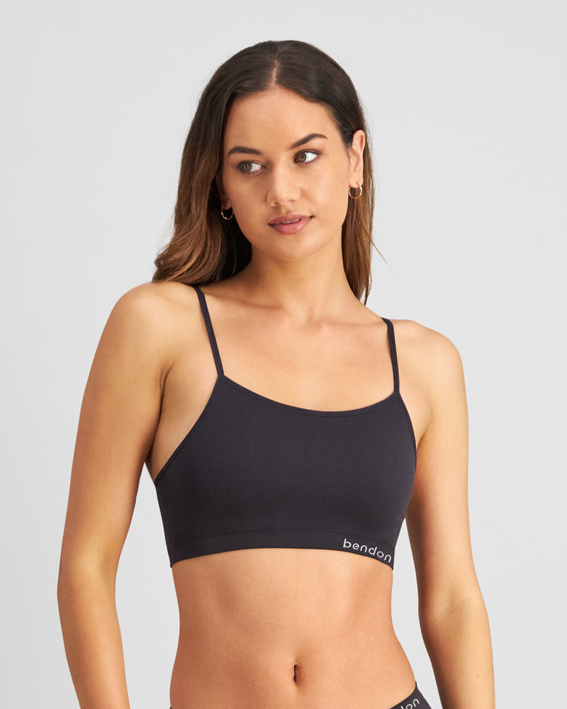 Model wears Simply Seamless Crop Top in BLACK. On body front view
