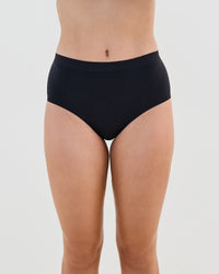 Model wears Seamless Soft Full Brief in BLACK. On body front view