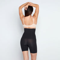 Model wears Medium Control High Waisted Shaper Short in BLACK. On body back view