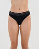 Model wears Cotton And Lace Thong in BLACK. On body front view