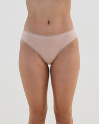 Model wears Stretch Cotton Bikini in LATTE. On body front view