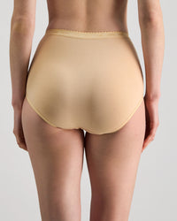 Model wears Freedom Full Brief in Nude. On body back view