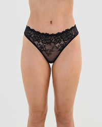 Model wears All Lacey Thong in BLACK. On body front view