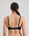 Model wears Simply Seamless Contour Bra in BLACK. On body back view