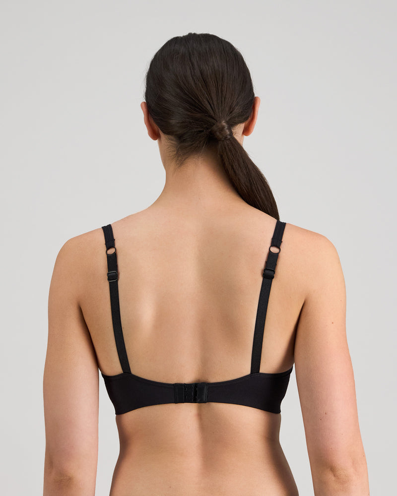 Model wears Simply Seamless Contour Bra in BLACK. On body back view