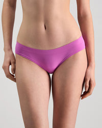 Model wears Seamless Soft Bikini in RADIANT ORCHID. On body front view