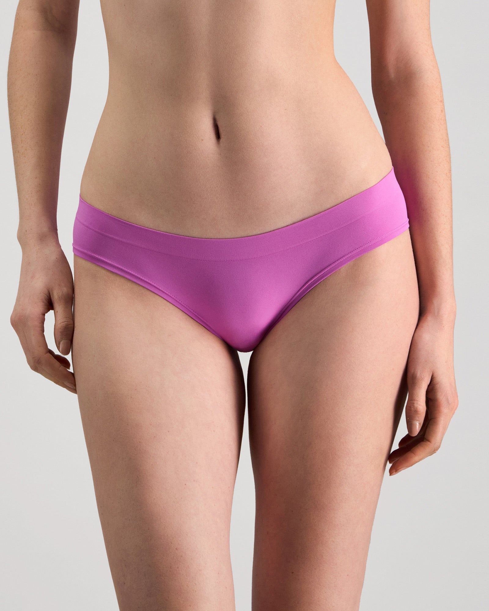 Model wears Seamless Soft Bikini in RADIANT ORCHID. On body front view