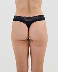 Model wears Cotton And Lace Thong in BLACK. On body back view