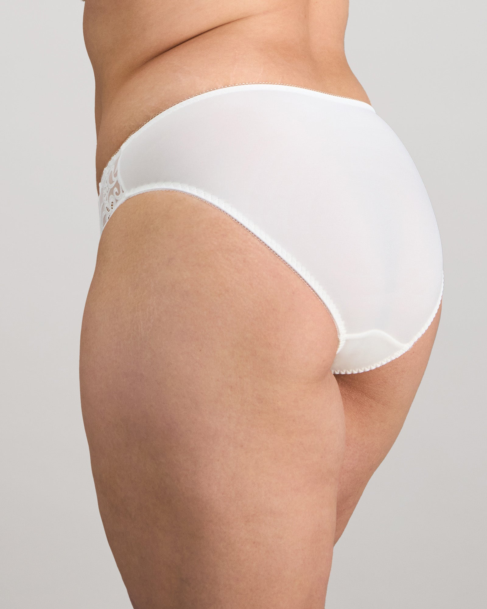 Model wears Coral High Cut Brief in WHITE. On body side view
