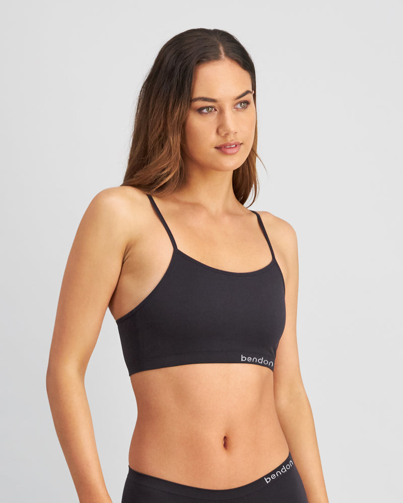 Model wears Simply Seamless Crop Top in BLACK. On body side view
