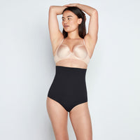 Model wears Medium Control High Waisted Brief in BLACK. On body front view