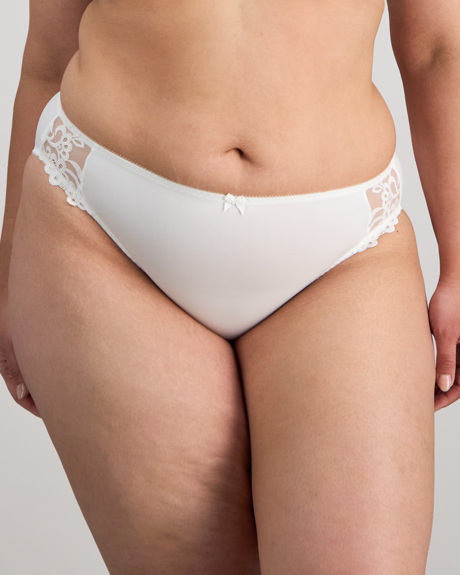 Model wears Coral High Cut Brief in WHITE. On body front view