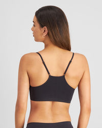 Model wears Simply Seamless Crop Top in BLACK. On body back view