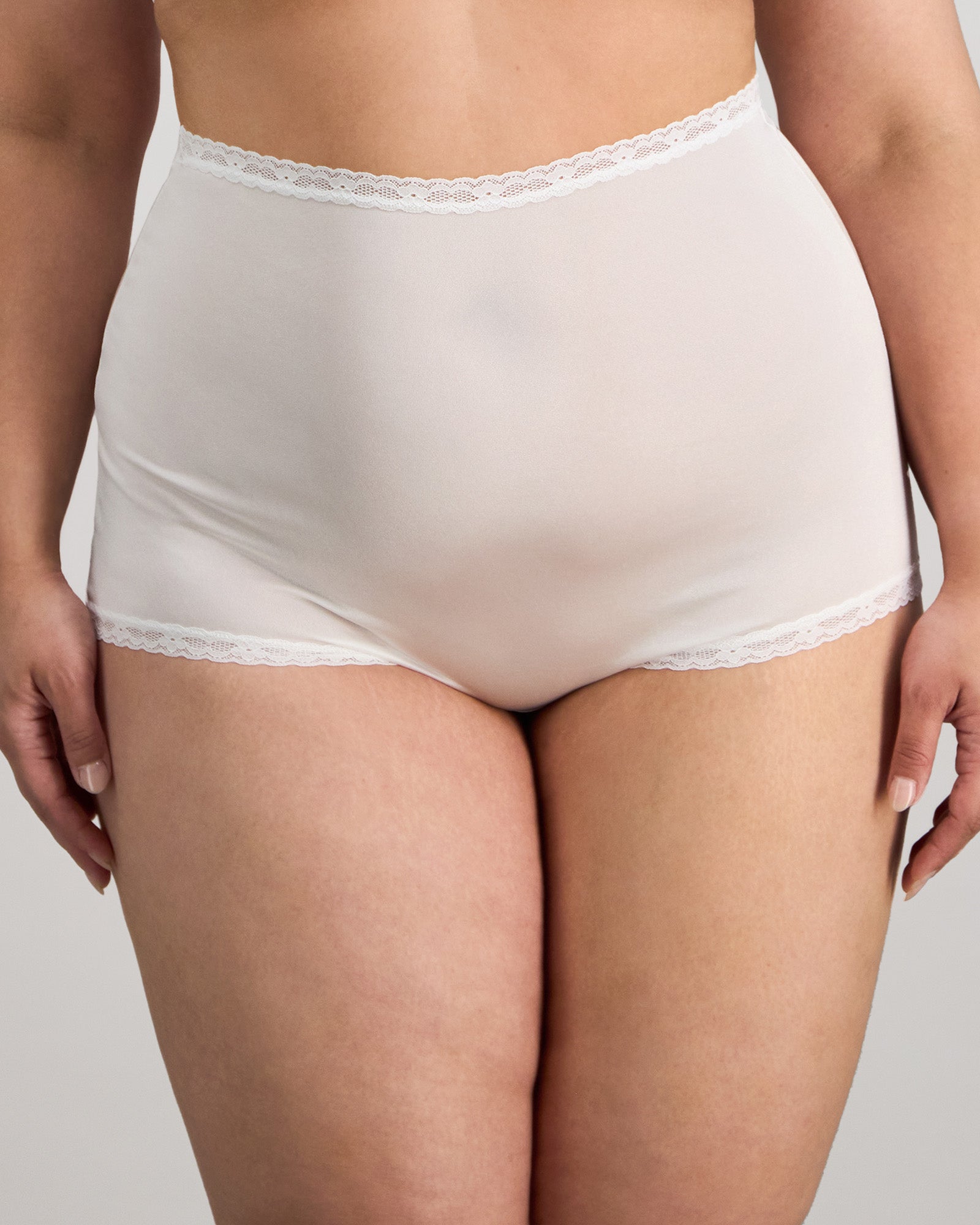 Model wears Nylon Tricot Full Brief in WHITE. On body front view