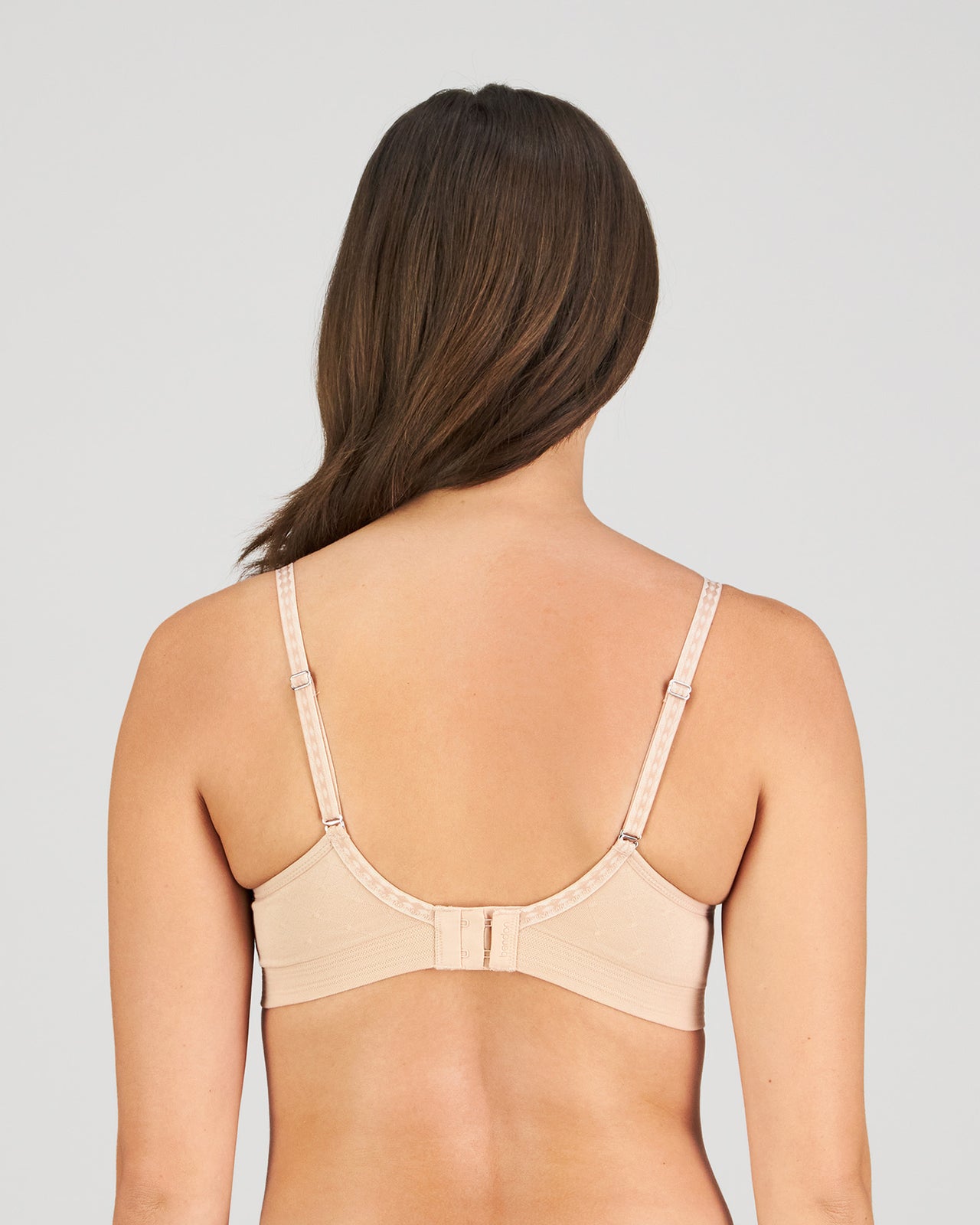 Model wears Bendon Body Lace Wire Free Bra in LATTE. On body back view