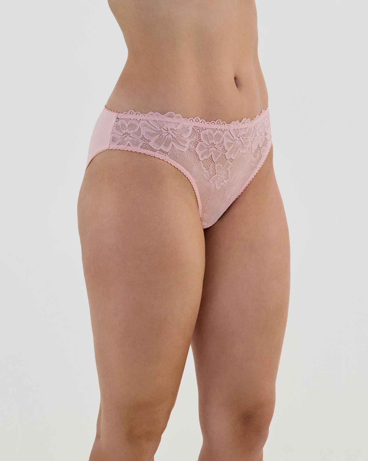 Model wears Lacey Bikini in SILVER PINK. On body side view