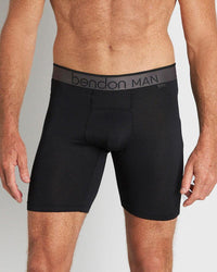 Model wears Everyday Active Mens Long Trunk in BLACK. On body front view