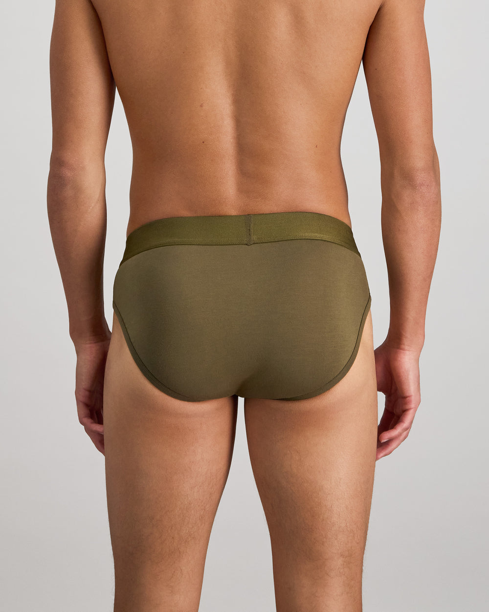Model wears Bamboo Mens Brief in DARK OLIVE. On body back view