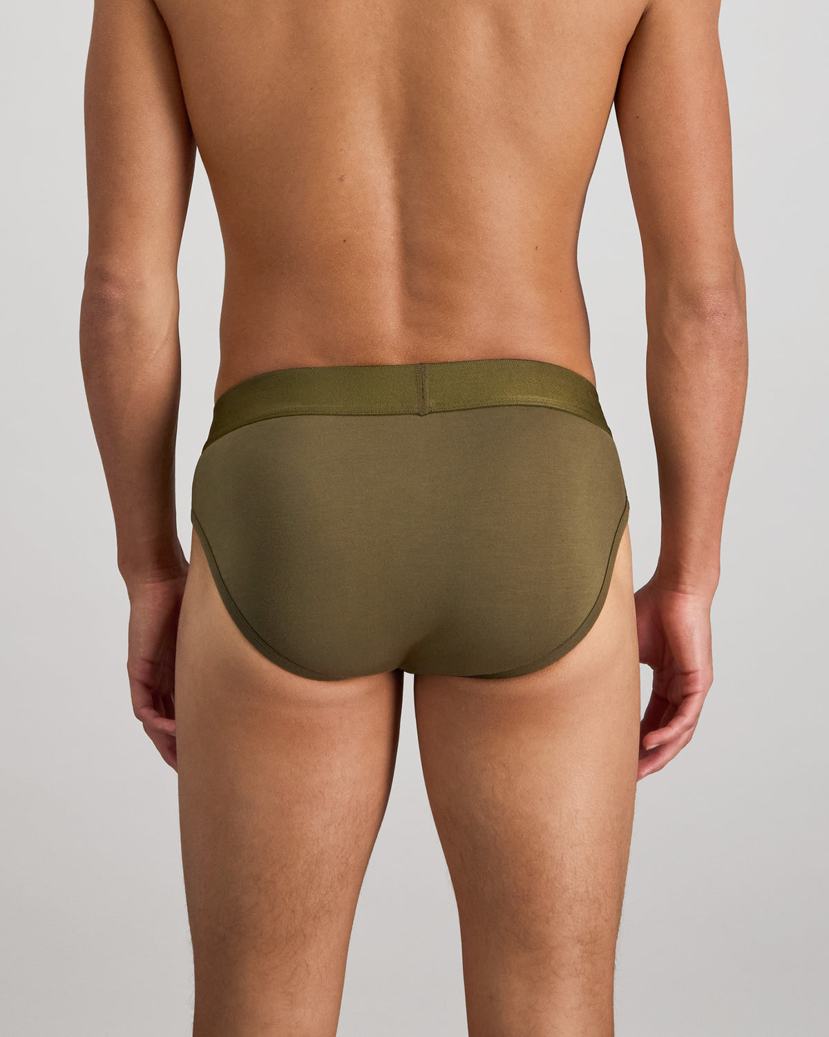 Model wears Bamboo Mens Brief in DARK OLIVE. On body back view