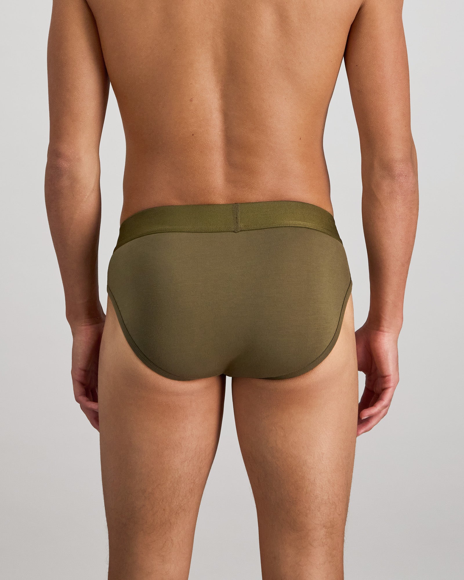 Model wears Bamboo Mens Brief in DARK OLIVE. On body back view