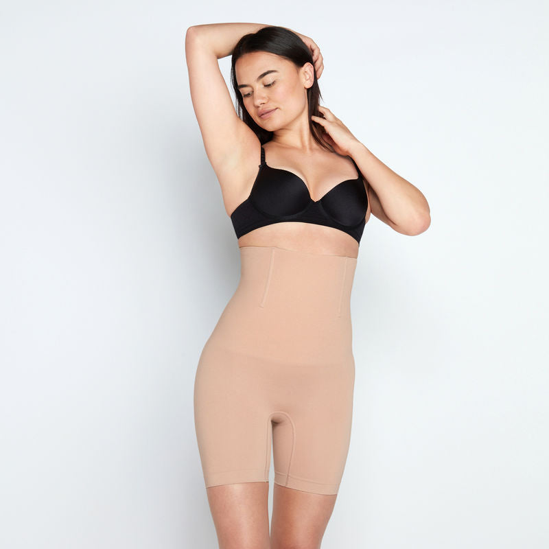 Model wears Medium Control High Waisted Shaper Short in CARAMEL. On body front view