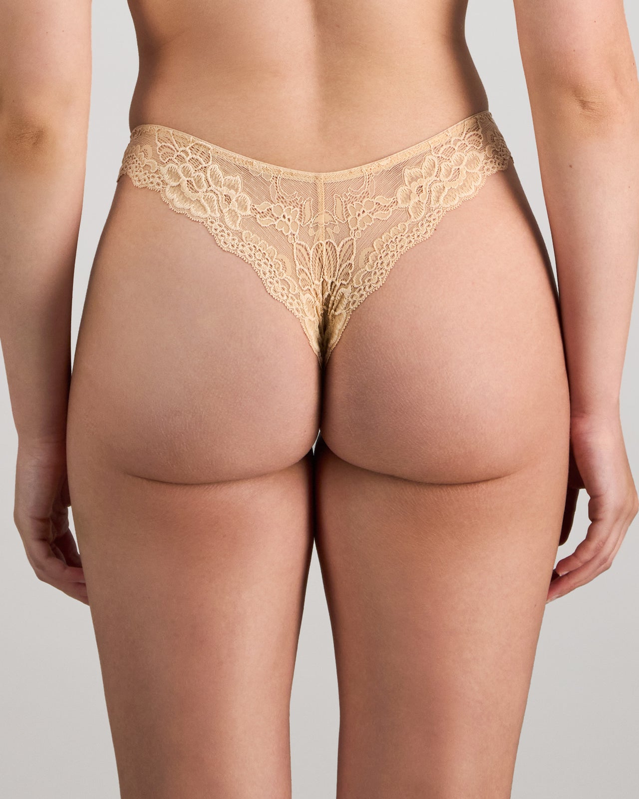 Model wears My Fit Lace Thong in FRAPPE. On body back view