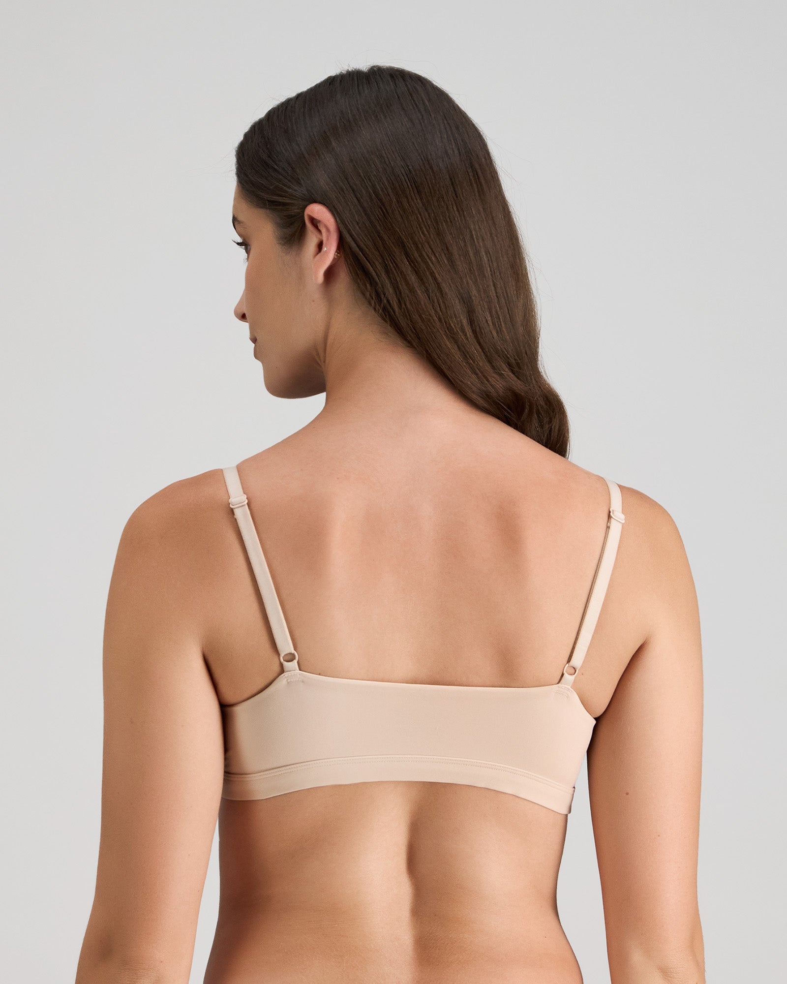 Model wears Extra-Ordinary Crop Top in LATTE. On body back view