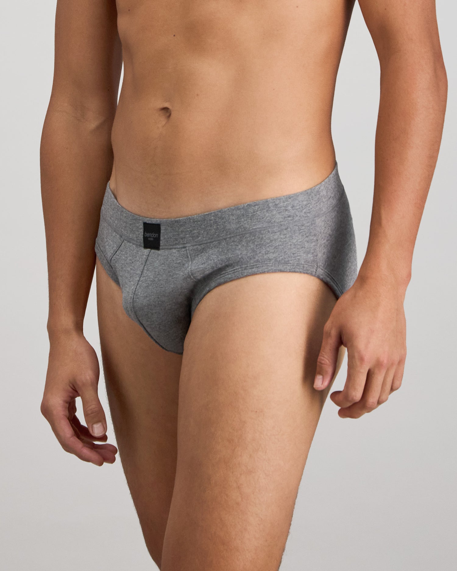 Model wears High Tech Cotton Mens Brief in GREY MARL. On body side view
