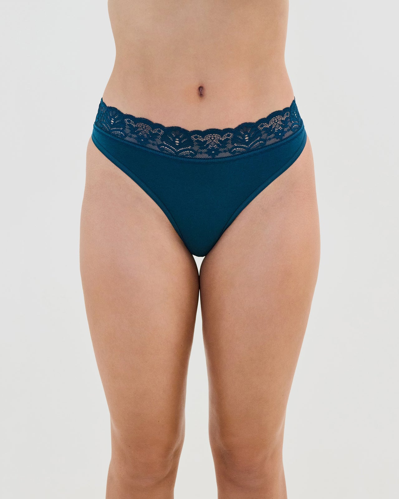Model wears Cotton And Lace Thong in REFLECTING POND. On body front view