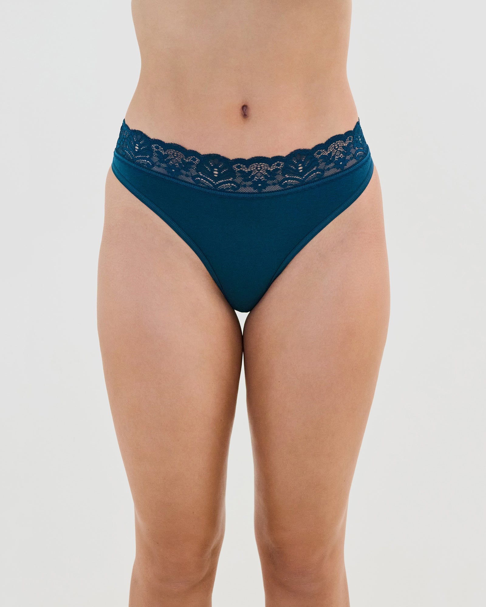 Model wears Cotton And Lace Thong in REFLECTING POND. On body front view