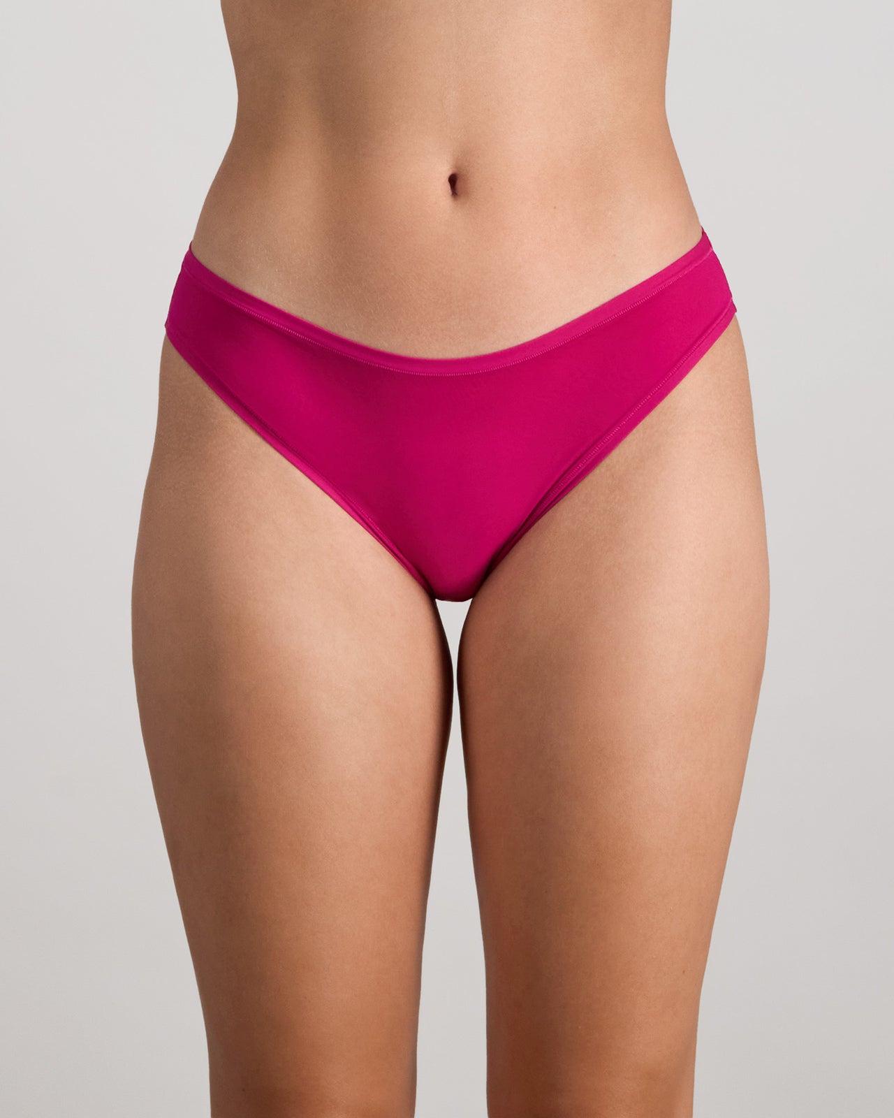 Model wears Extra-Ordinary Bikini in FANTASY FUCHSIA. On body front view
