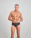 Model wears Cotton Stretch Mens Brief in CHAR BLACK. On body front view