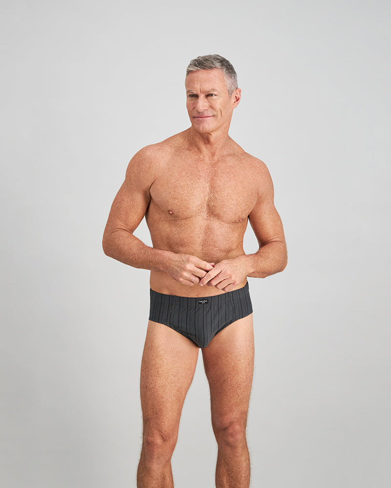 Model wears Cotton Stretch Mens Brief in CHAR BLACK. On body front view