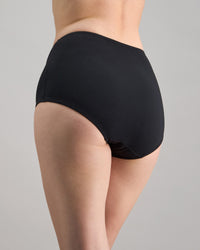 Model wears Freestyle Full Brief in BLACK. On body back view