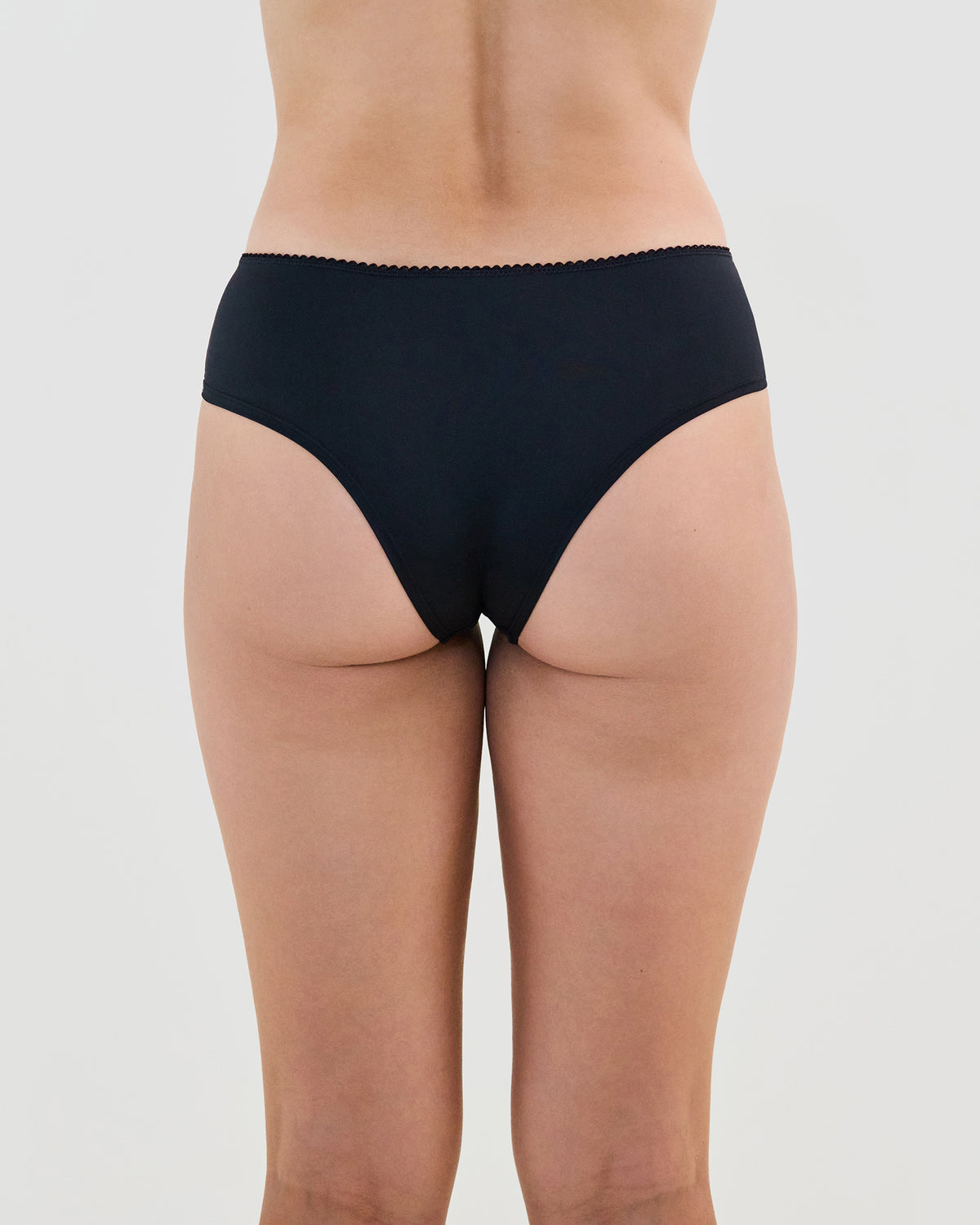 Model wears Lacey Brazilian in BLACK. On body back view