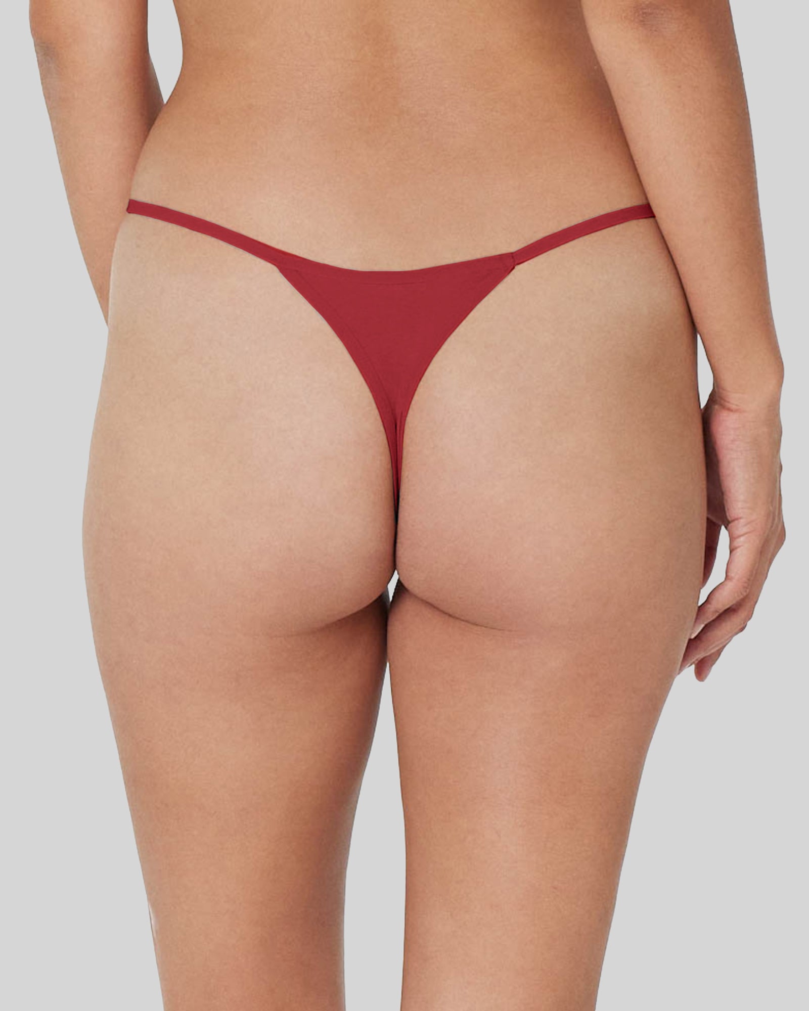 Model wears Clemence Thong in JESTER RED. On body back view