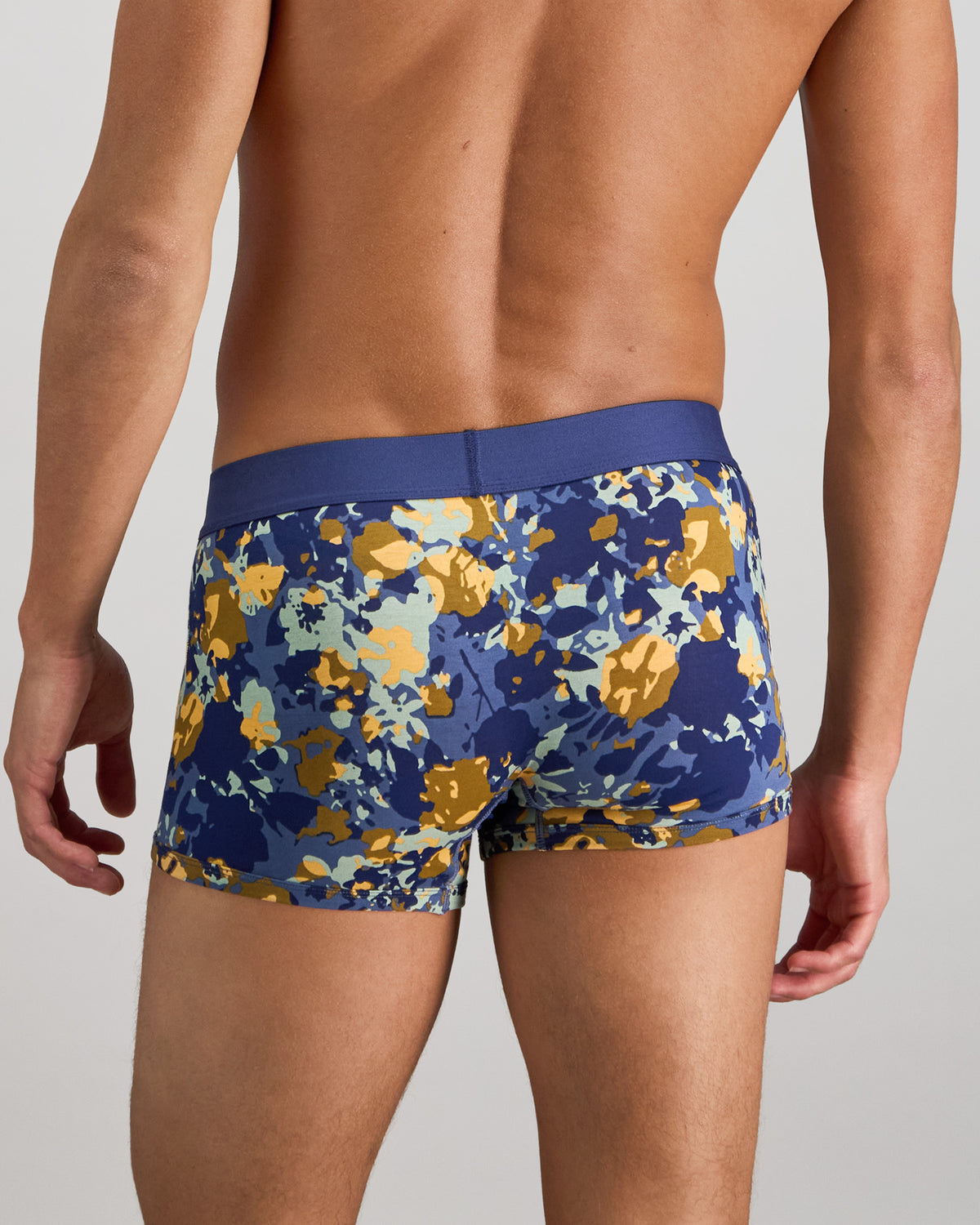 Model wears Retros Print Mens Trunk in WILD CAMO PRINT. On body back view