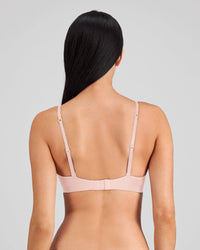 Model wears Simply Seamless Wire Free Bra in SILVER PINK. On body back view