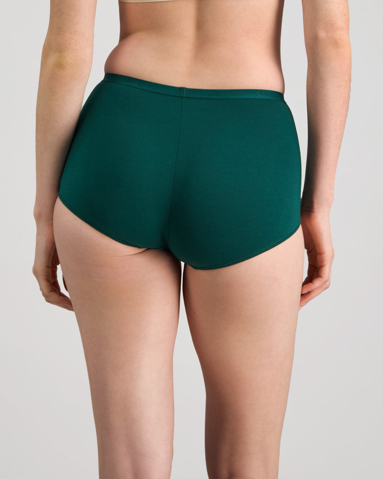 Model wears Body Cotton Full Brief in RAIN FOREST. On body back view