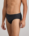 Model wears Cotton Stretch Mens Brief in BLACK PINSTRIPE. On body side view