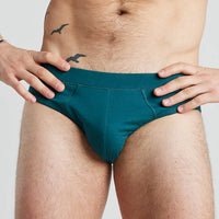 Model wears High Tech Cotton Mens Brief in DEEP TEAL. On body front view