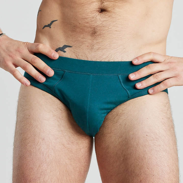 Model wears High Tech Cotton Mens Brief in DEEP TEAL. On body front view