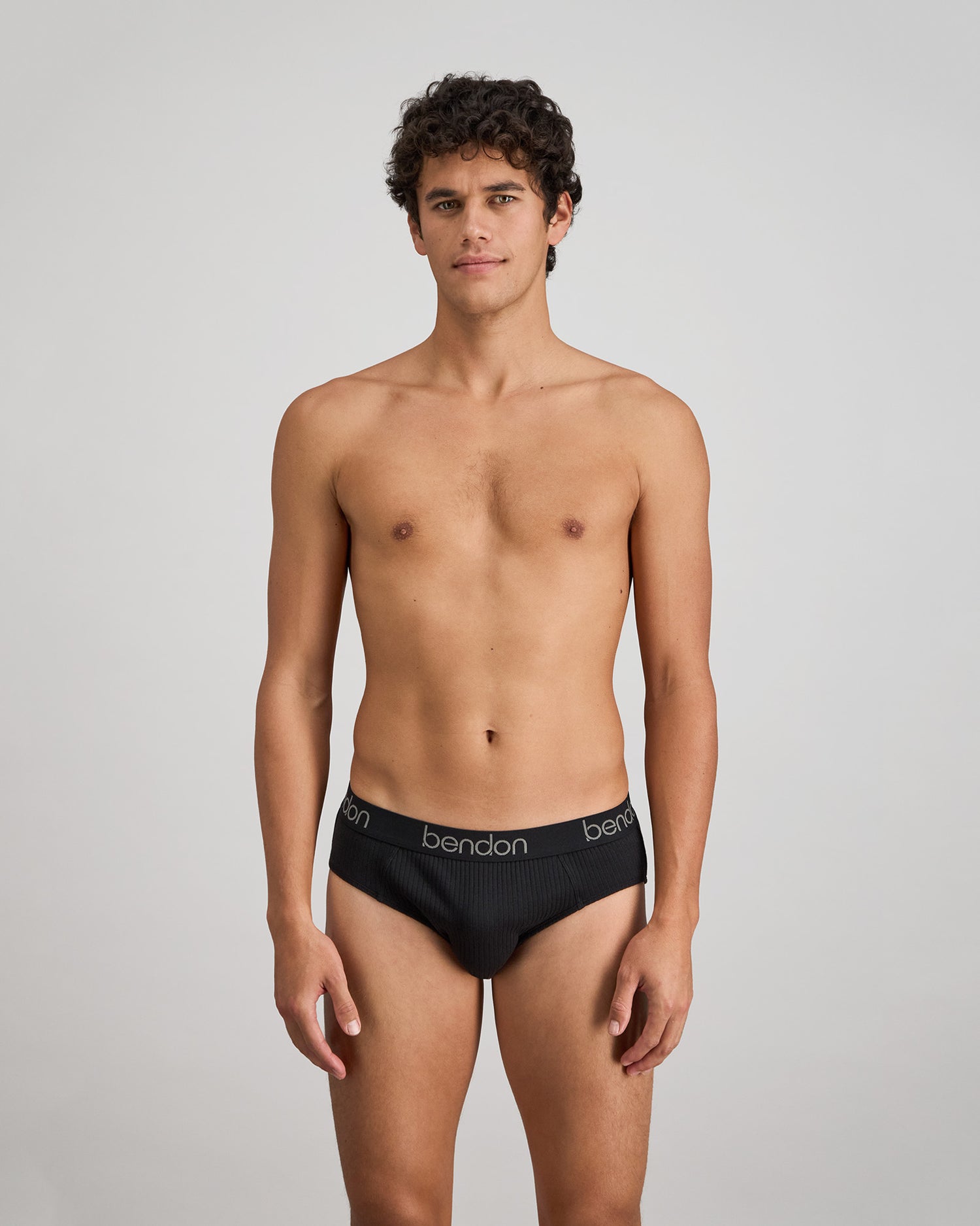 Model wears Cotton Texture Mens Brief in BLACK. On body front view