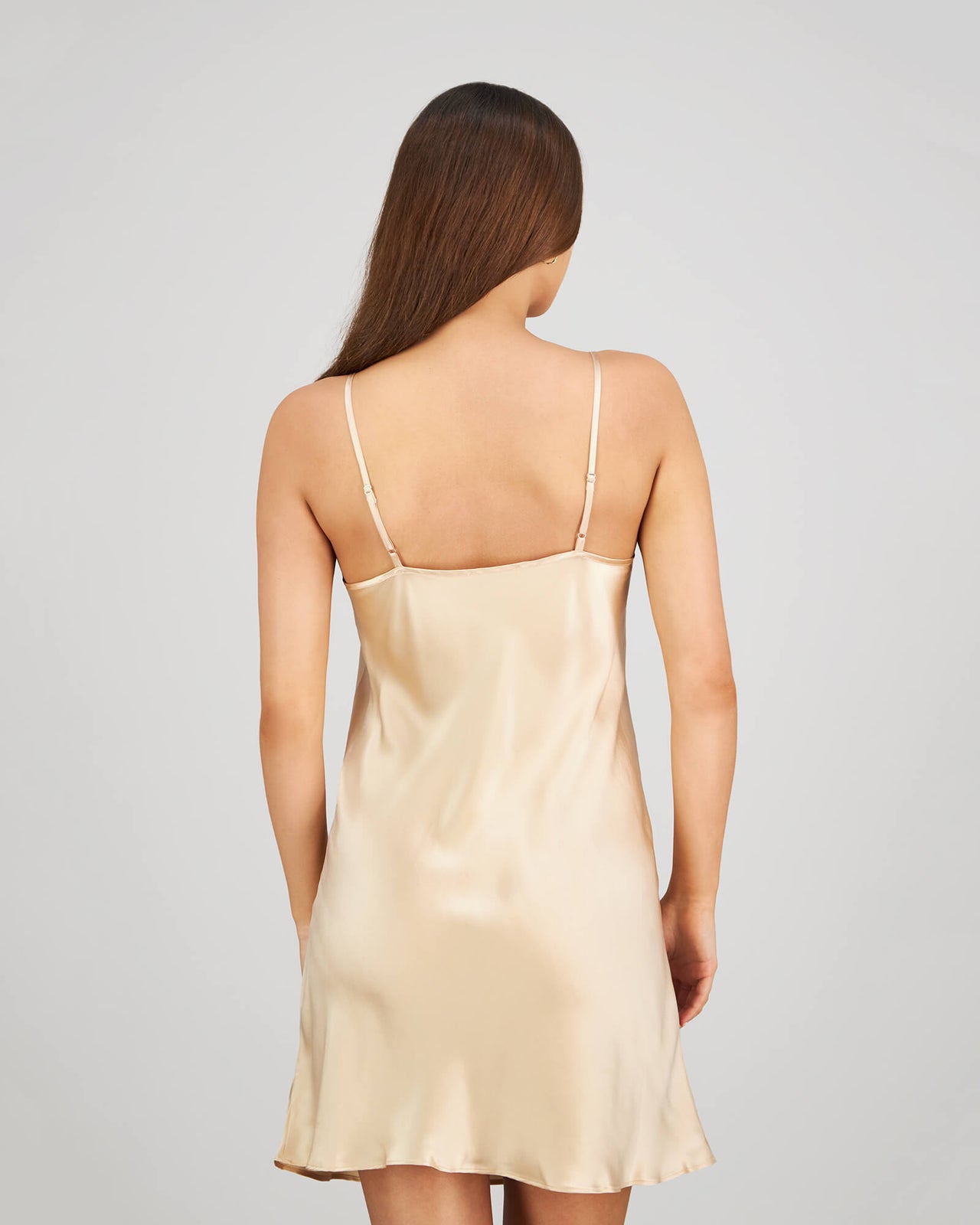 Model wears Silk Brilliance Chemise in CHAMPAGNE. On body back view